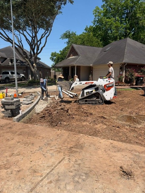 Apex crew and compact track loader completing residential drainage work