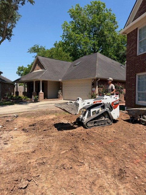 Apex operator grading soil with a compact track loader