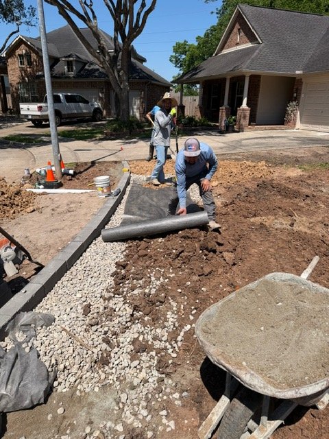 Apex crew preparing geotextile fabric in a drainage trench